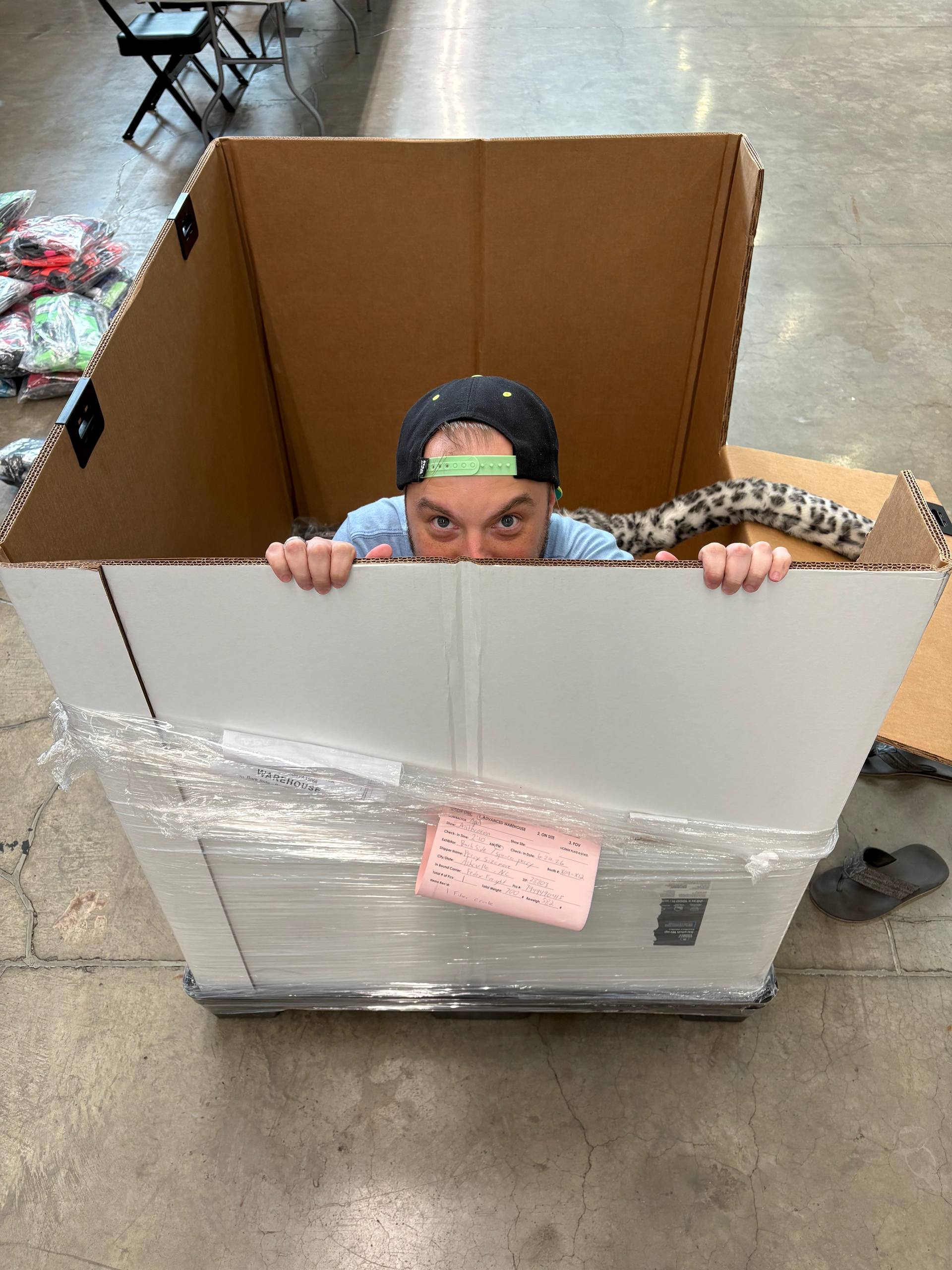 Frostbyte preparing for a convention in a large packing box
